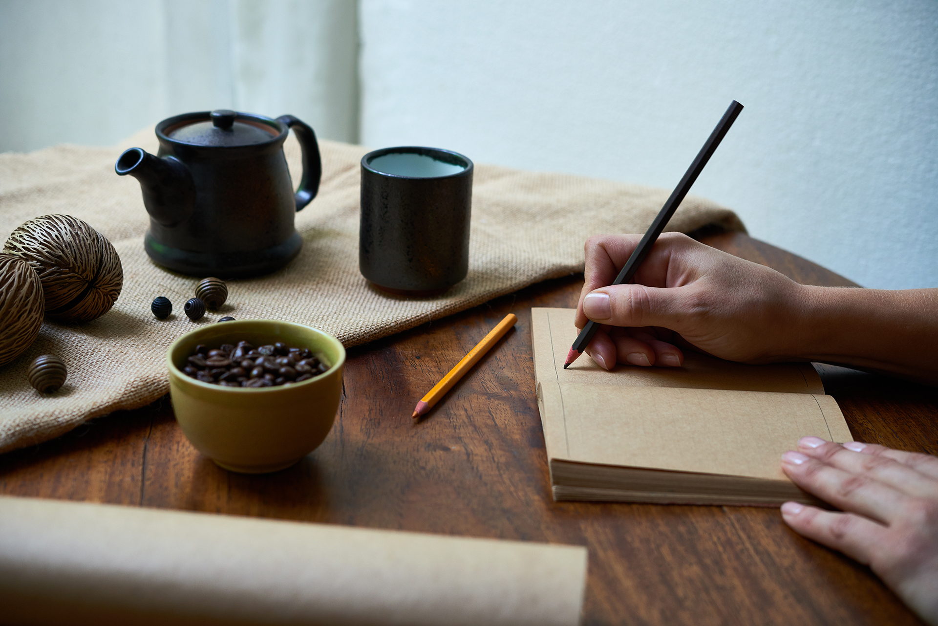 Writer working at desk with tea and notebook